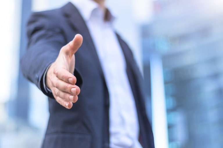 Waukesha Businessman with an open hand ready for handshake